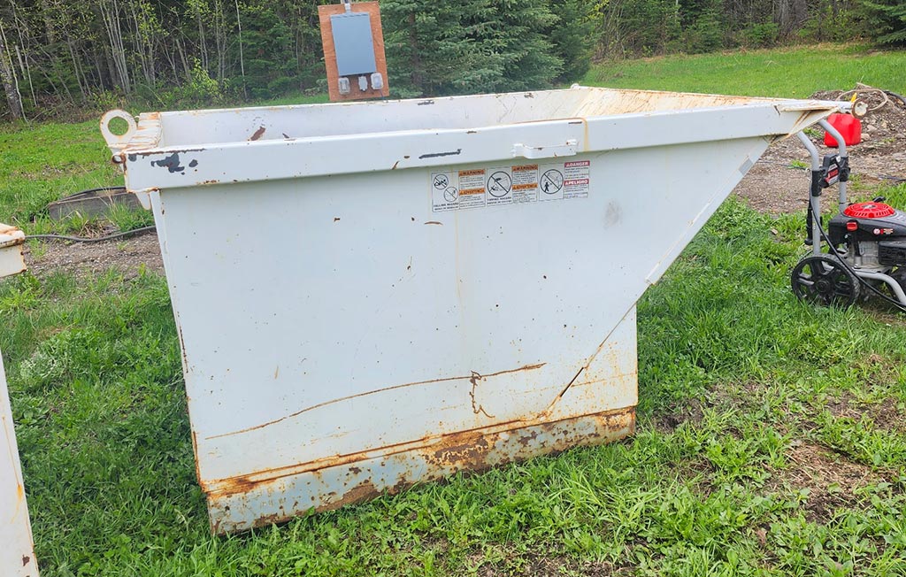 White and rusty industrial garbage bin